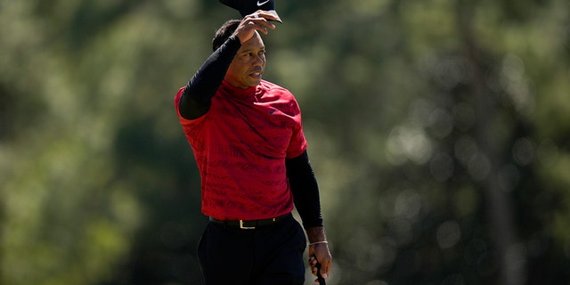 Tiger Woods tips his cap on the 18th hole during the final round at the Masters golf tournament on Sunday, April 10, 2022, in Augusta, Ga. 