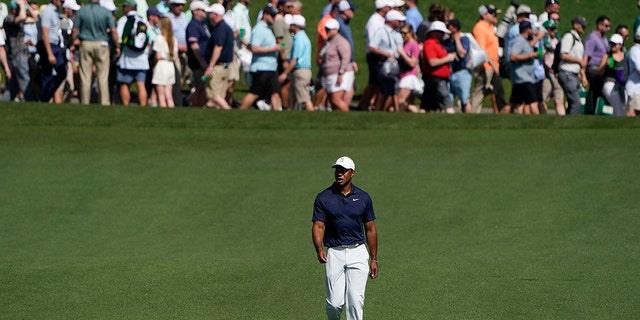 Tiger Woods walks down the fourth fairway during a practice round for the Masters golf tournament on Monday, April 4, 2022, in Augusta, Georgia.