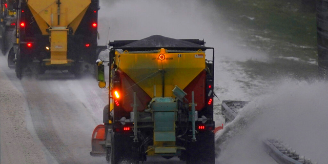 Snow plows remove snow and ice from Interstate 85/40 as a winter storm moves through the area near Hillsborough, N.C., Sunday, Jan. 16, 2022. 