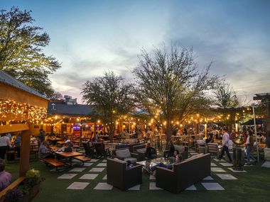 Guests relax on the patio as the sun sets at Smoky Rose restaurant.