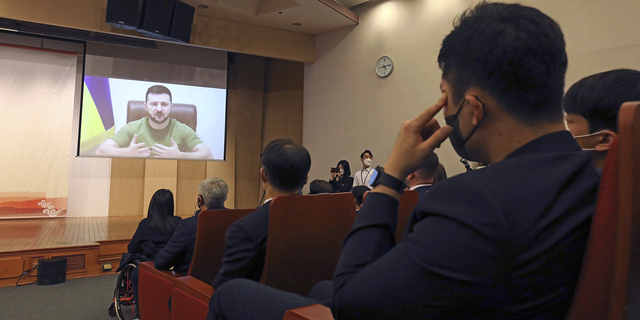 Ukrainian President Volodymyr Zelenskyy addresses members of the South Korea Parliament via video link at the National assembly on Monday.