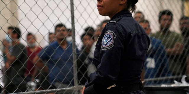 A U.S. Customs and Border Protection agent monitors single-adult male detainees at Border Patrol station in McAllen, Texas, U.S. July 12, 2019.