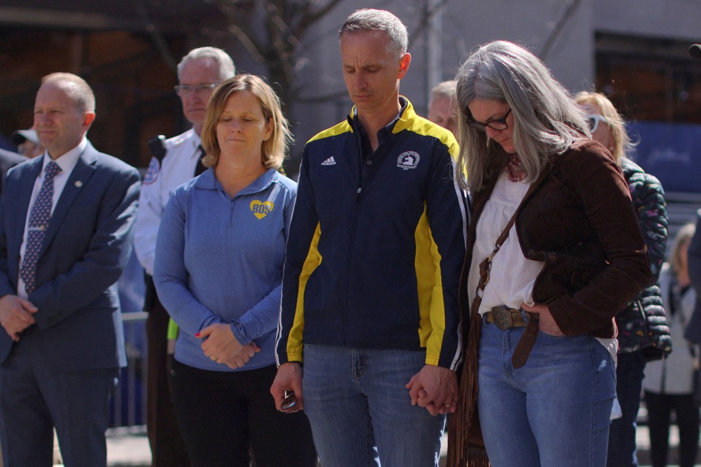 Bill and Denise Richard observing a moment of silence before the Boston Marathon at the site of one of the 2013 bomb blasts.