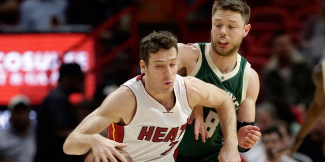 Miami Heat guard Goran Dragic (7) drives to the basket as Milwaukee Bucks guard Matthew Dellavedova (8) defends during the first half of an NBA basketball game, Thursday, Nov. 17, 2016, in Miami. Dragic is now with the Nets.