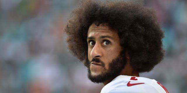 San Francisco 49ers quarterback Colin Kaepernick watches from the sidelines during the Dolphins game in Miami Gardens, Florida, on Nov. 27. 2016.