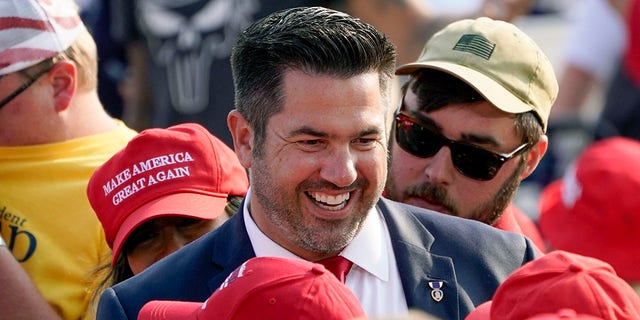 Sean Parnell walks through people gathered at a campaign rally for President Donald Trump at the Pittsburgh International Airport in Moon Township, Pa. 