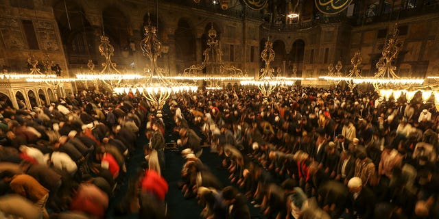 Muslim worshippers perform a night prayer called "tarawih" during the eve of the first day of the Muslim holy fasting month of Ramadan at Hagia Sophia mosque in Istanbul, Turkey, Friday, April 1, 2022. 