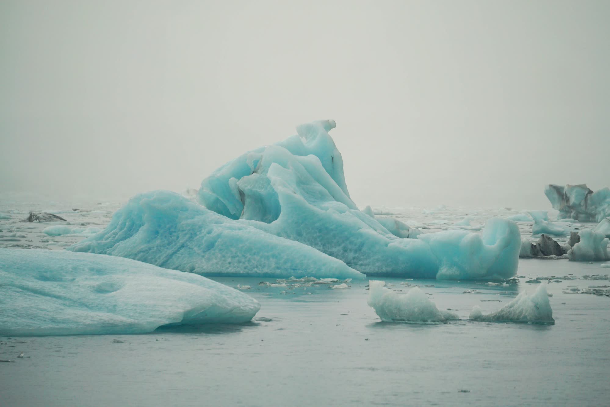 Large chunks of sea ice float in a lagoon.