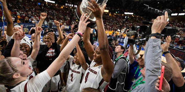 South Carolina's Aliyah Boston holds up the championship trophy after defeating Tennessee 74-58 to win the championship game of the Southeastern Conference women's tournament in Greenville, S.C., Sunday, March 5, 2023.
