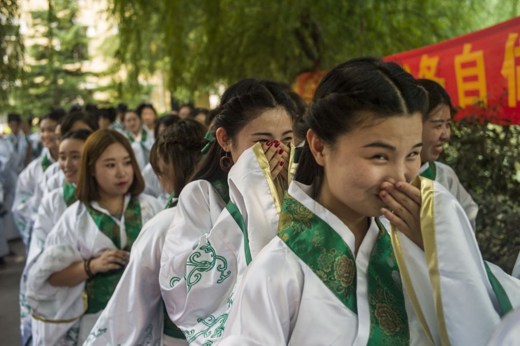 Chinese college students during a formal ceremony.