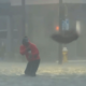 FOX Weather reporter caught in strong flood water dodges palm tree debris