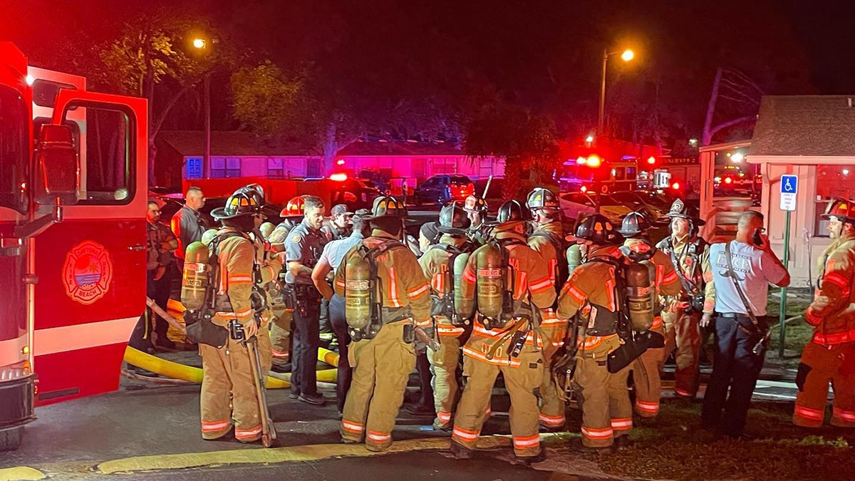 firefighters gathered in the street