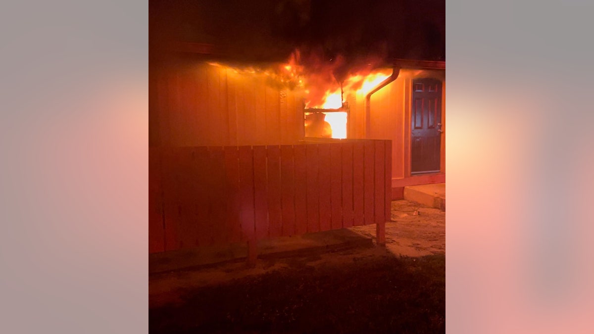 fire bursting through window of apartment