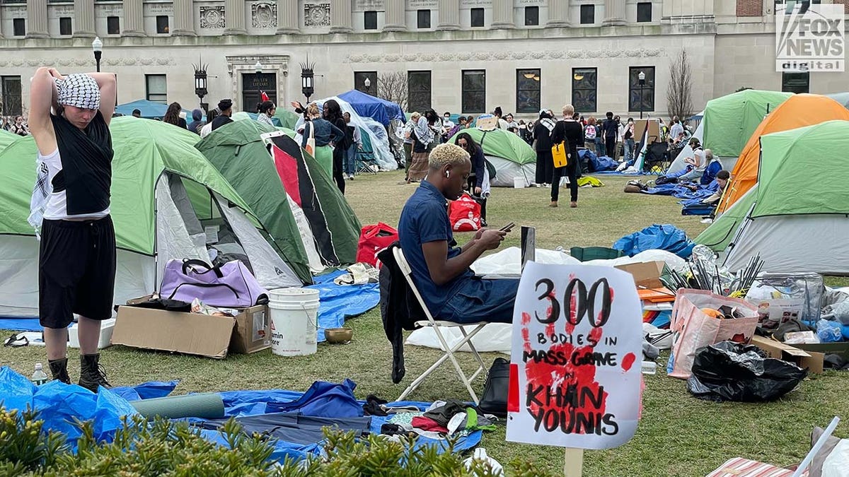 Anti-Israel agitators relax inside an encampment set up on the West Lawn at Columbia University in New York City