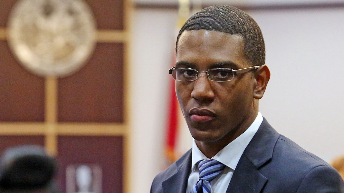 Dante Martin wearing glasses and a dark suit in court