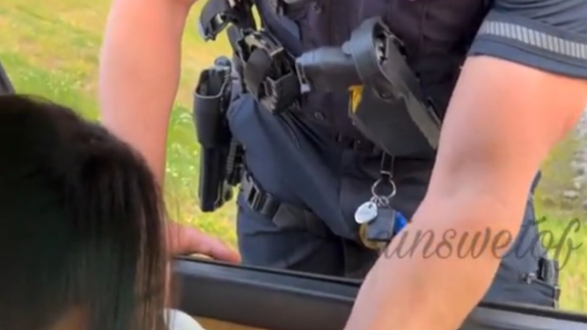 Officer's uniform and arms visible in video