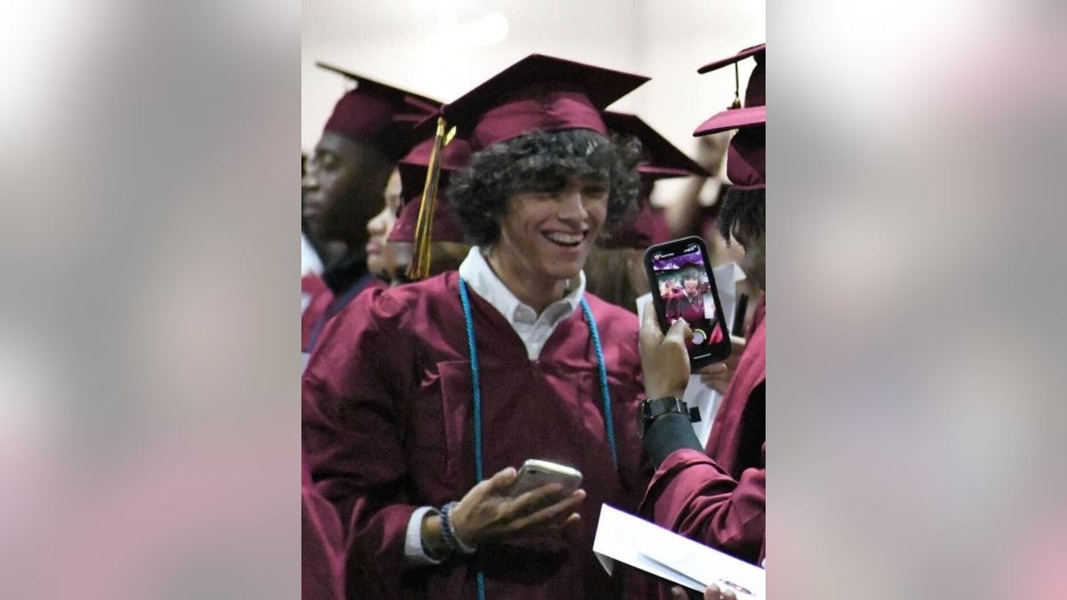 Gavin Guffey in a graduation gown