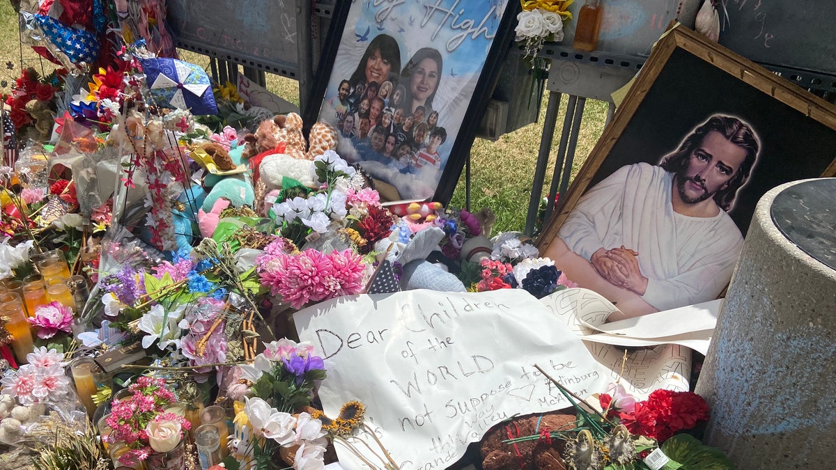 Signs and flowers lay in Uvalde's town square memorial