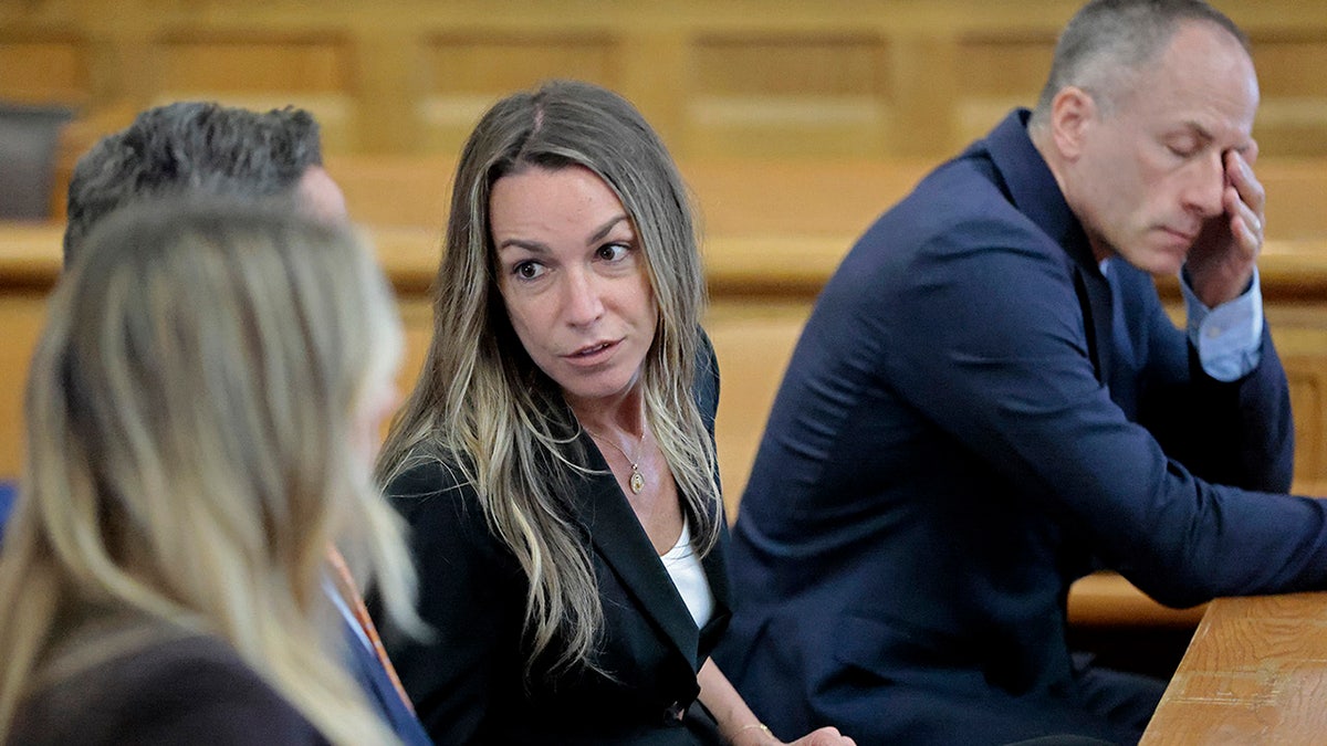 Karen Read talks with her legal team at the Norfolk Superior Court in Dedham, Mass