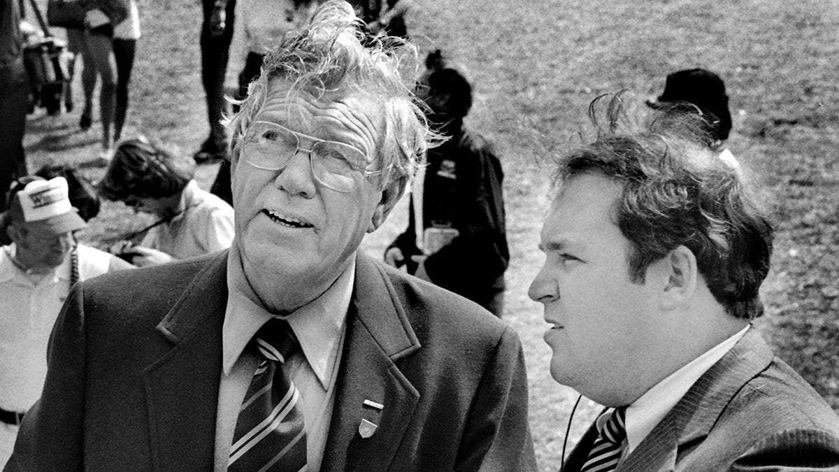 NASCAR founder and former CEO Bill France Sr., left, talks with a U.S. Secret Service agent regarding security for Vice President George H.W. Bush prior to the start of the 1983 Daytona 500 stock car race at Daytona International Speedway in Daytona Beach. Bush served as the race's honorary starter.