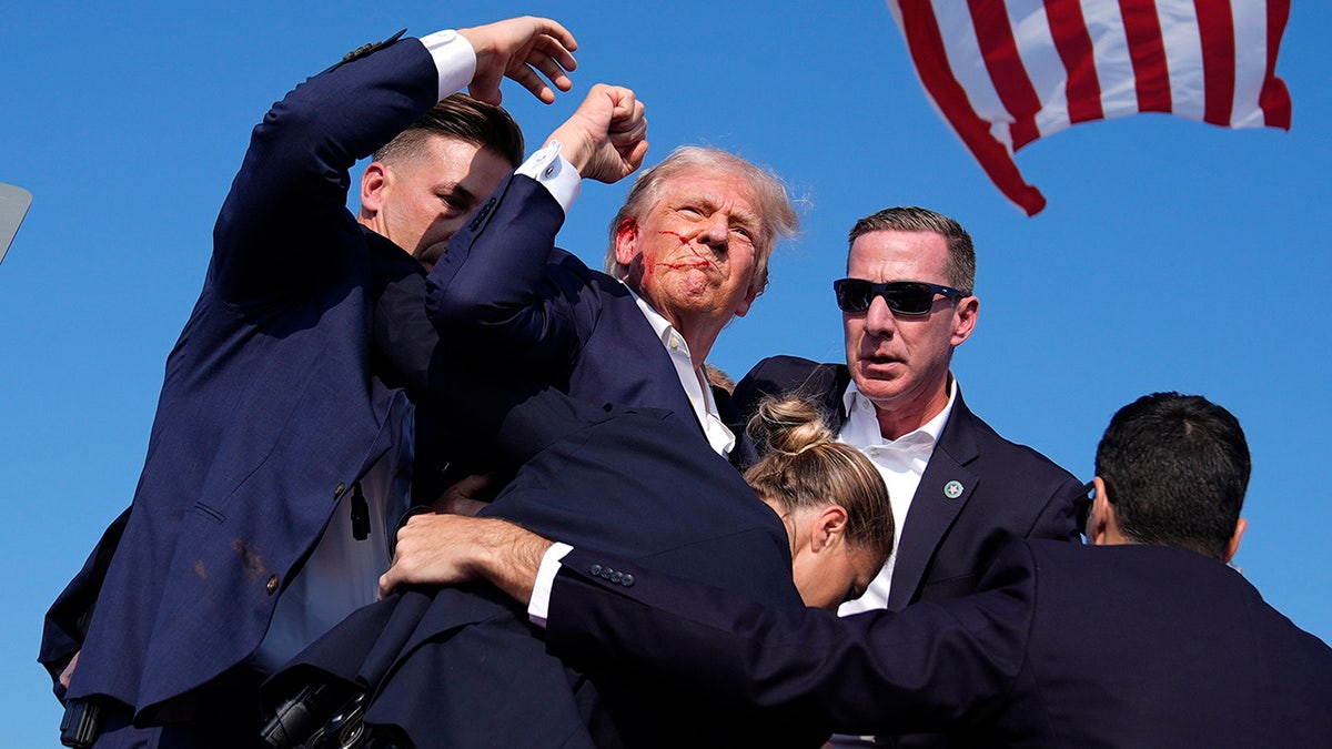 Former President Donald Trump is surrounded by U.S. Secret Service agents