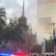 Smoke rises above the historic First Baptist Church in downtown Dallas