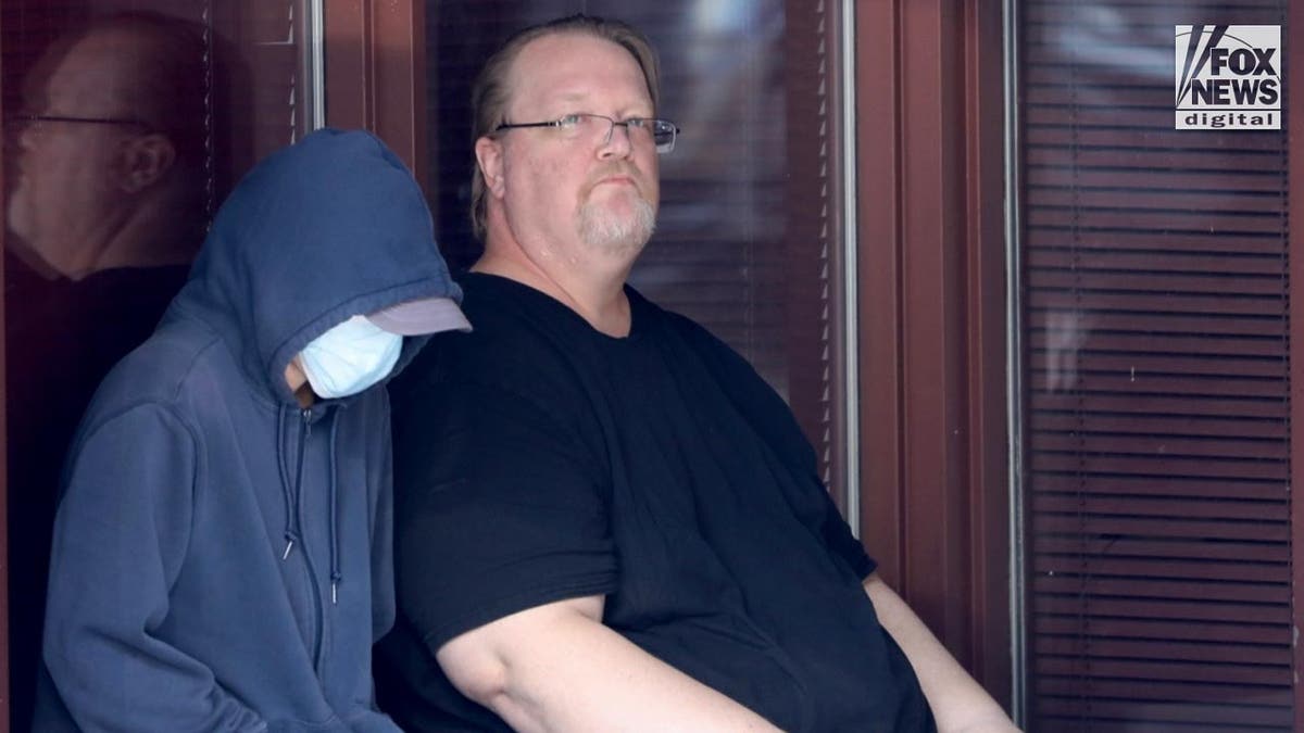 Trump assassin's father Matthew Crooks waits outside of an office building