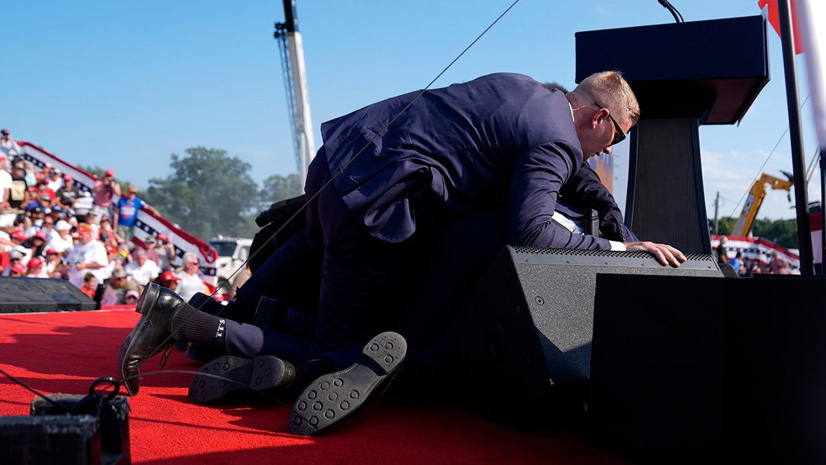 Republican presidential candidate former President Donald Trump is covered by U.S. Secret Service agents