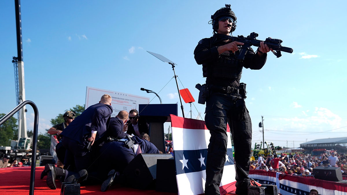 Republican presidential candidate former President Donald Trump is covered by U.S. Secret Service agents