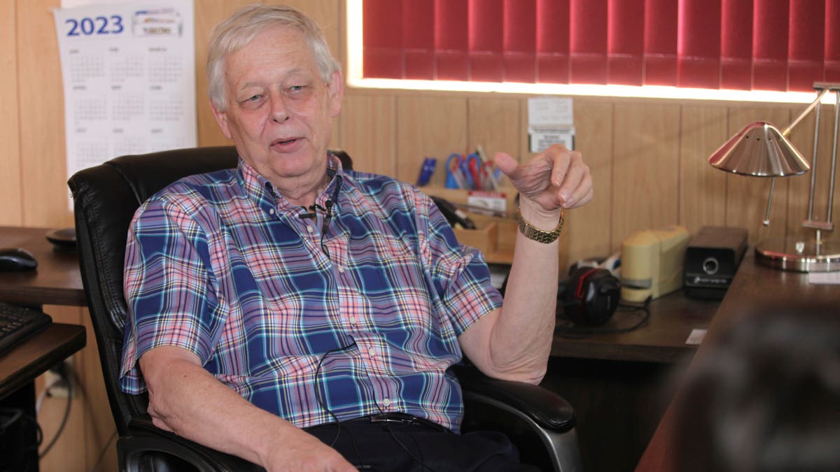 Marion County Record Publisher Eric Meyer in office chair wearing plaid shirt