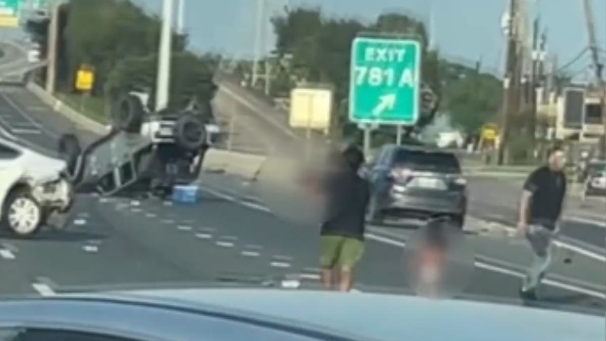 Father picks up his child after highway crash