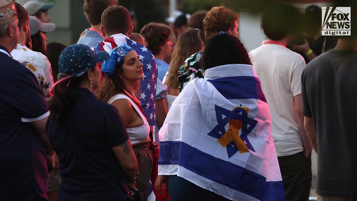 Students draped in American and Israeli flags