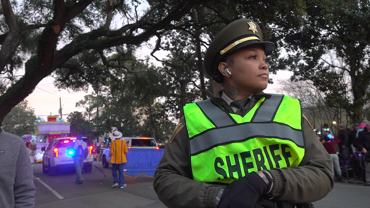 Woman in sheriff's office uniform watching the crowd at the parade