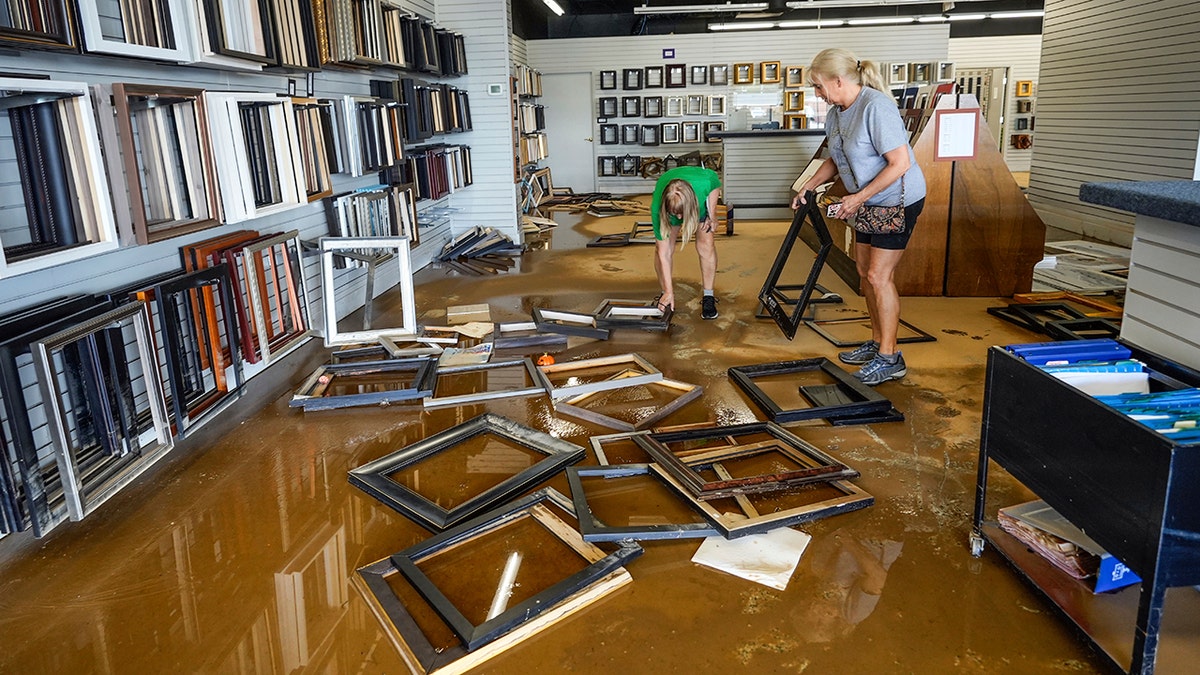 business owners clean up flooding from hurricane helene