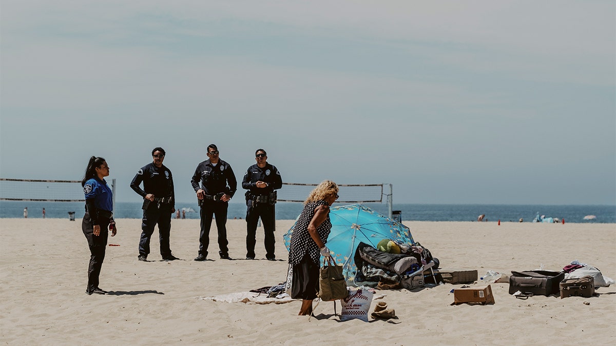 The Los Angeles Police Department oversees the dismantling of a homeless encampment off of the Venice Beach boardwalk in Venice, California, on Aug. 5, 2024.