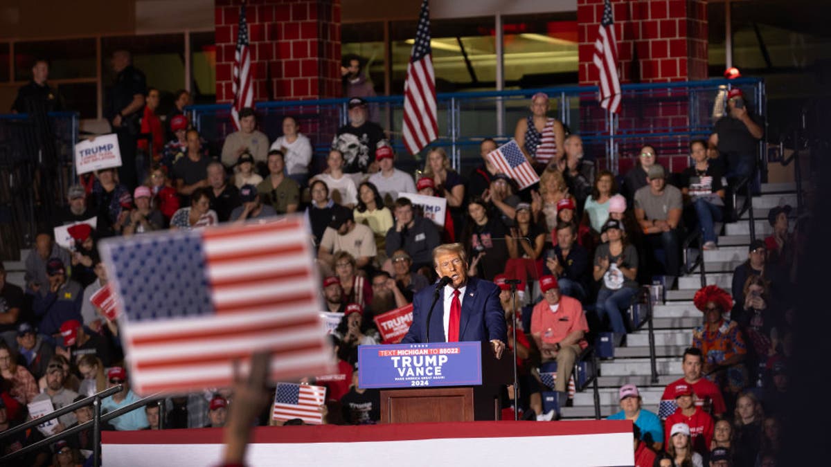 Trump at lectern seen in wide shot from rally