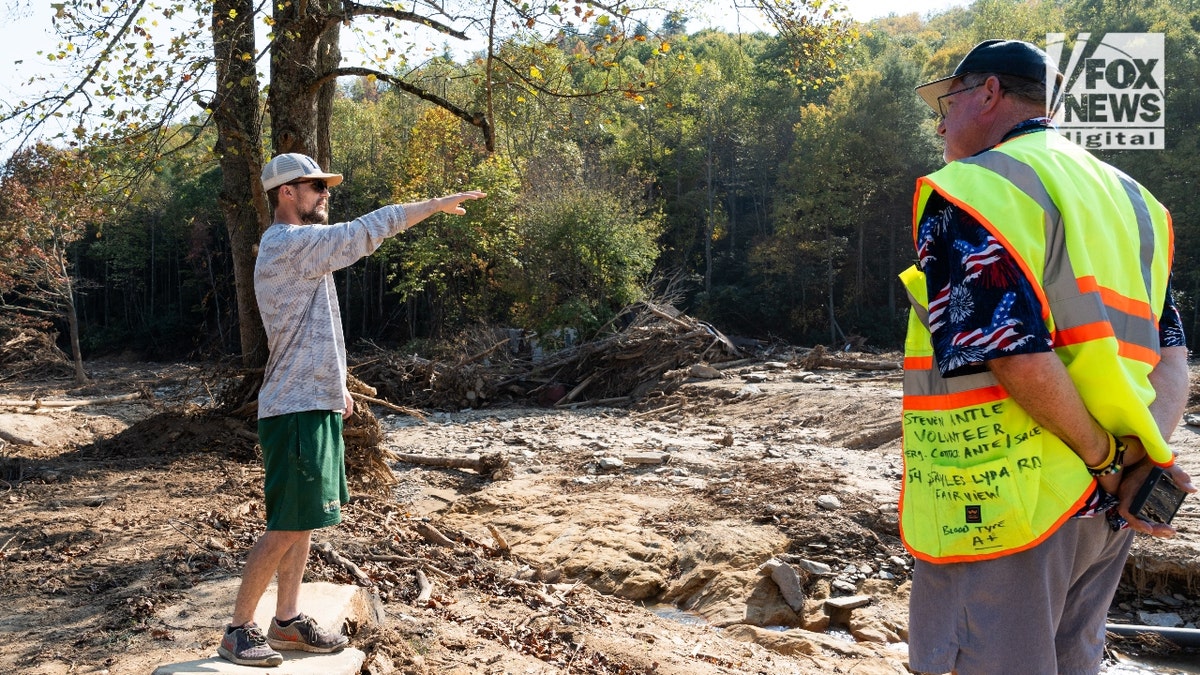 Jesse Craig, who lost 11 family members to mudslides in Fairview, N.C., points to devastation in the neighborhood known as 'Craigtown.'