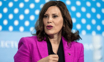 Michigan gov feeds kneeling female podcast host Doritos while wearing a Harris-Walz hat