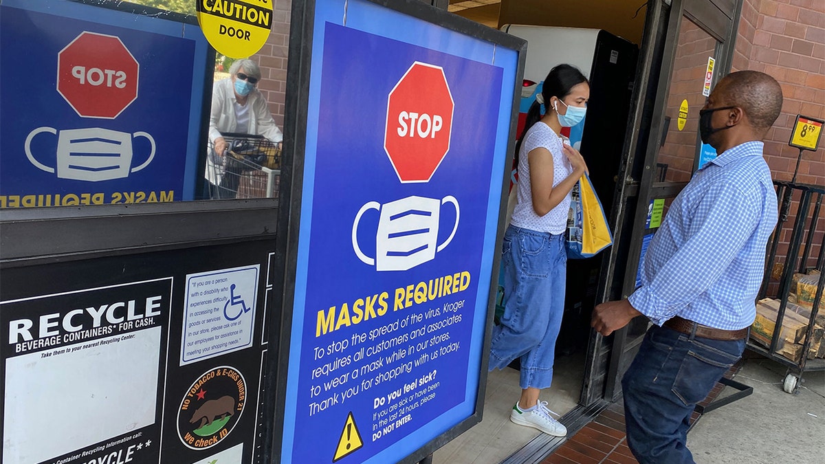 A sign says "masks required" in California during the COVID-19 pandemic