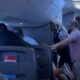 Passengers intervene on flight when man allegedly attacks woman next to him, video shows