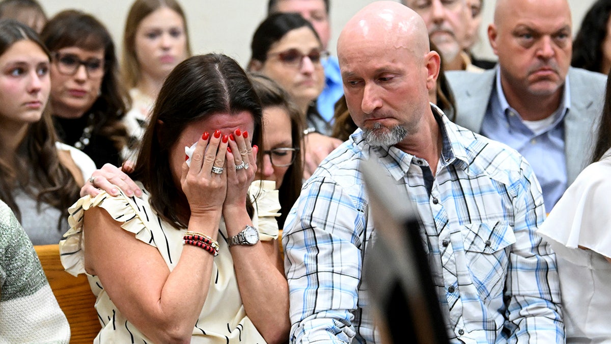 Allyson Phillips, left,, mother of Jose Ibarra, accused of killing a Georgia nursing student earlier this year reacts as John Phillips, stepfather of Jose Ibarra, comforts her during Ibarra's trial