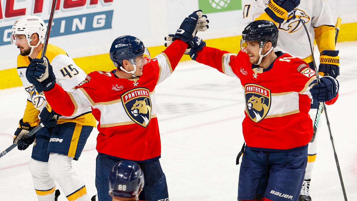 Panthers player Tomas Nosek, left, is congratulated by A.J. Greer after his first career goal in a game against the Nashville Predators, Nov. 7, 2024, in Sunrise, Florida.