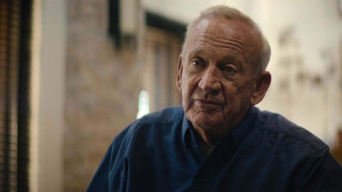 A close-up of John Ramsey in a blue shirt.