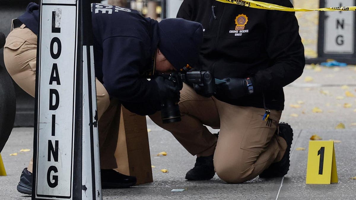 Police investigate the bullet at the scene of CEO Brian Thompson's murder in New York City