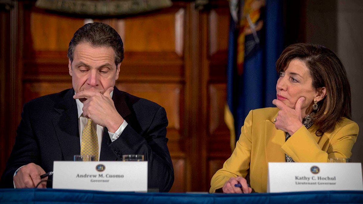 Then-Lt. Gov. Kathy Hochul looks at then-Gov. Andrew M. Cuomo of New York.