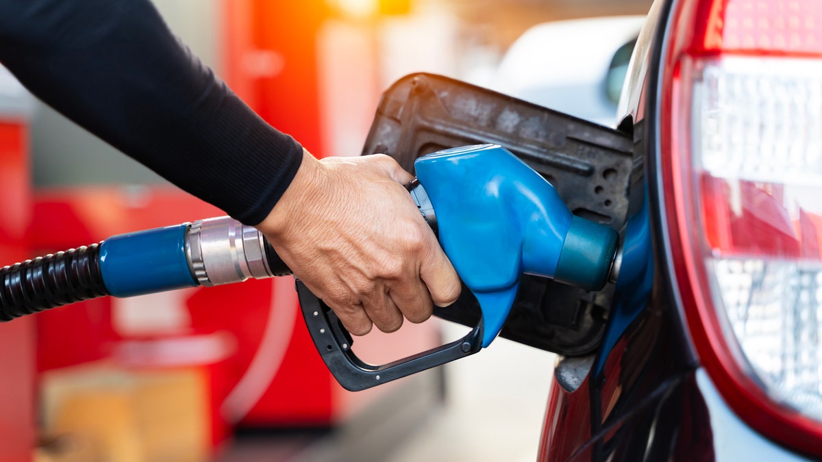 Person filling up their car with gas