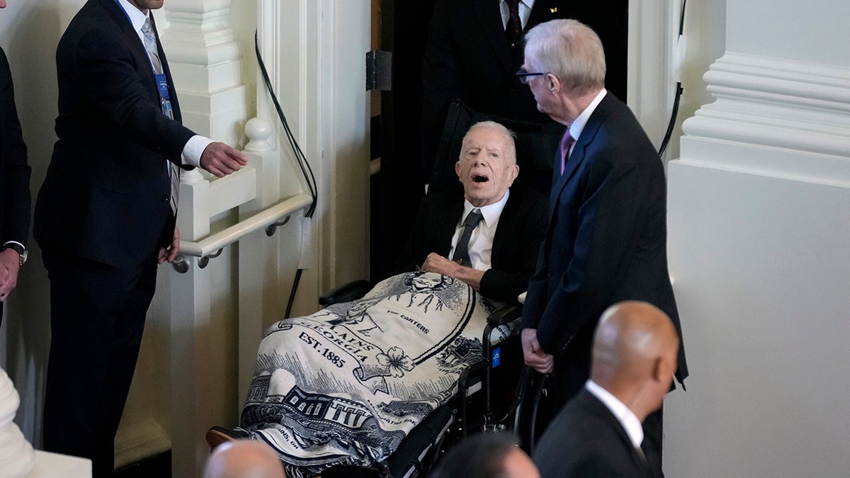 Jimmy Carter in wheelchair at wife's tribute