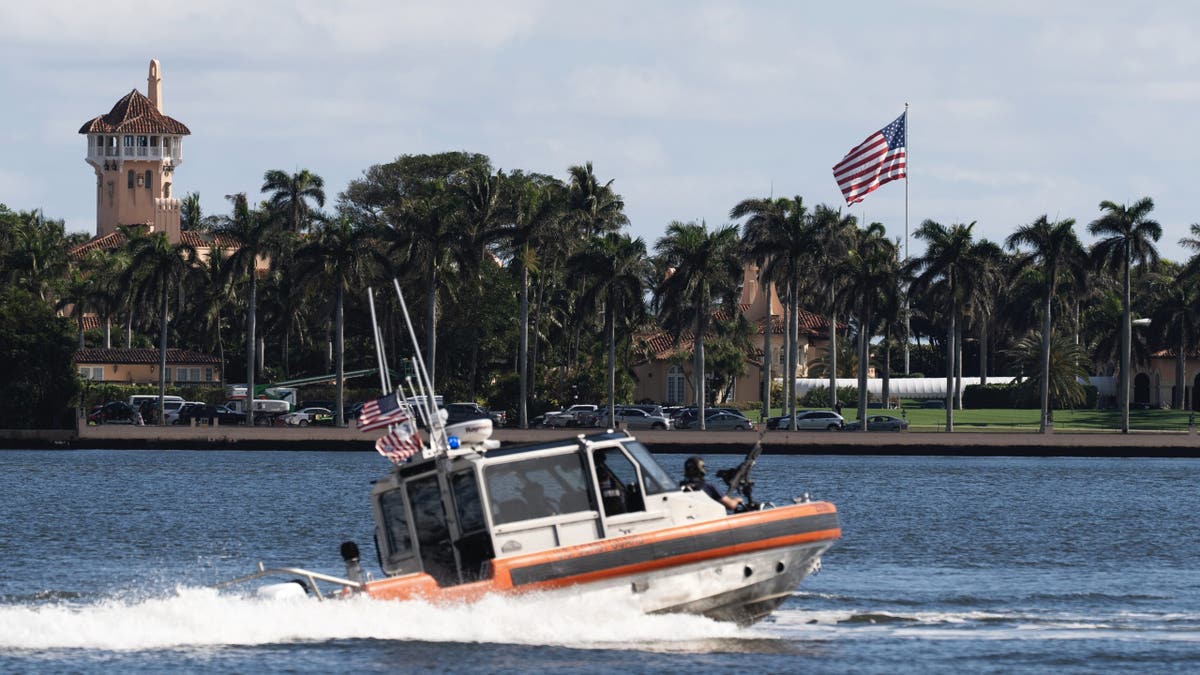 The U.S. flag is shown at the Mar-a-Lago compound in Palm Beach, Fla., while a U.S. Coast Guard boat patrols around the vicinity, Monday, Jan. 13, 2025. U.S. flags at President-elect Donald Trump's private Mar-a-Lago club are back to flying at full height. Flags are supposed to fly at half-staff through the end of January out of respect for former President Jimmy Carter, who died Dec. 29. (AP Photo/Manuel Balce Ceneta)