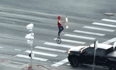 Fire-juggling unicyclist caught on camera blocking traffic in major roadway as police intervene