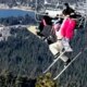 Skier’s prank backfires, leaving her dangling 65 feet in the air as twin desperately holds on